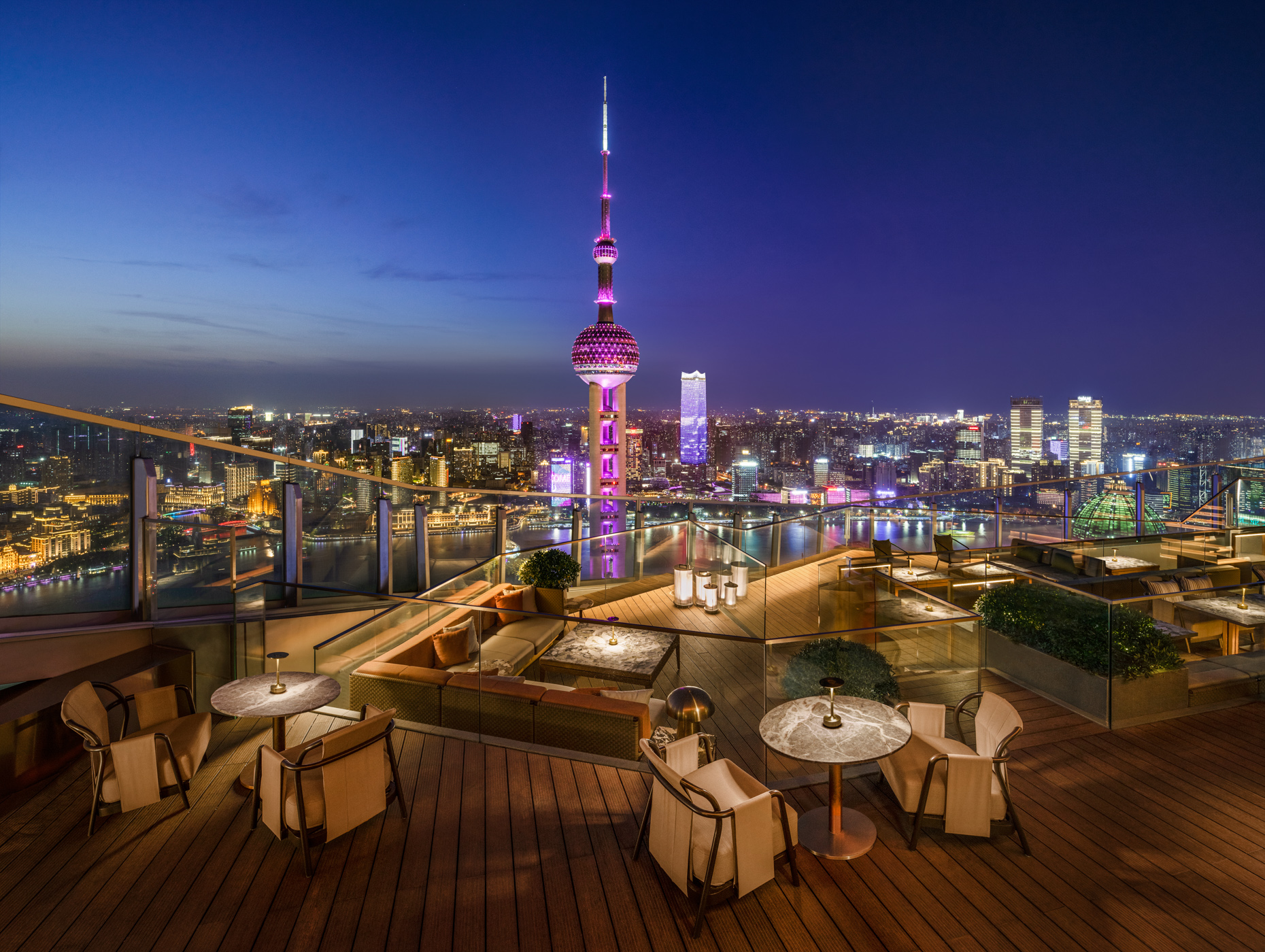 Shanghai skyline and the Oriental Pearl Tower viewed from a rooftop terrace at night